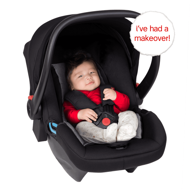 phil&teds alpha™ infant car seat shown with a cute baby safely harnessed into the capsule_black/grey marl